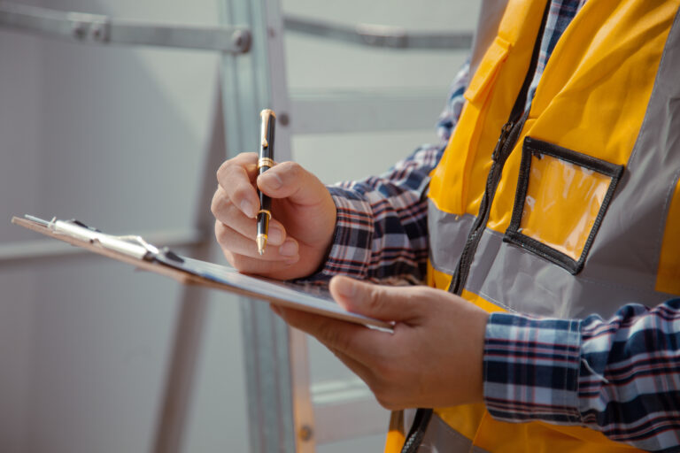 a contractor carrying out checks on a clipboard